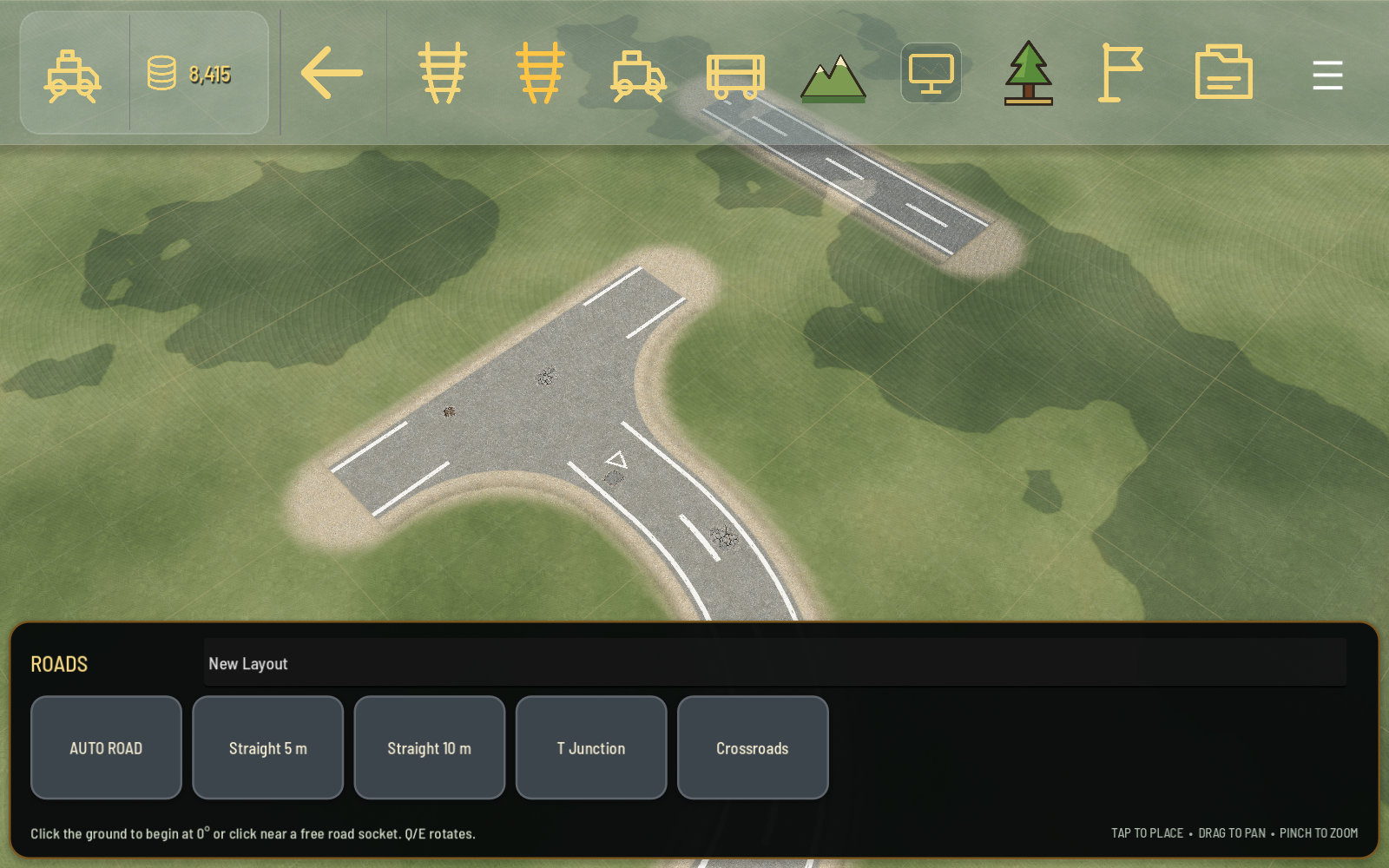 Shunt's custom layout editor showing a road-component palette, placement grid and a road junction.
